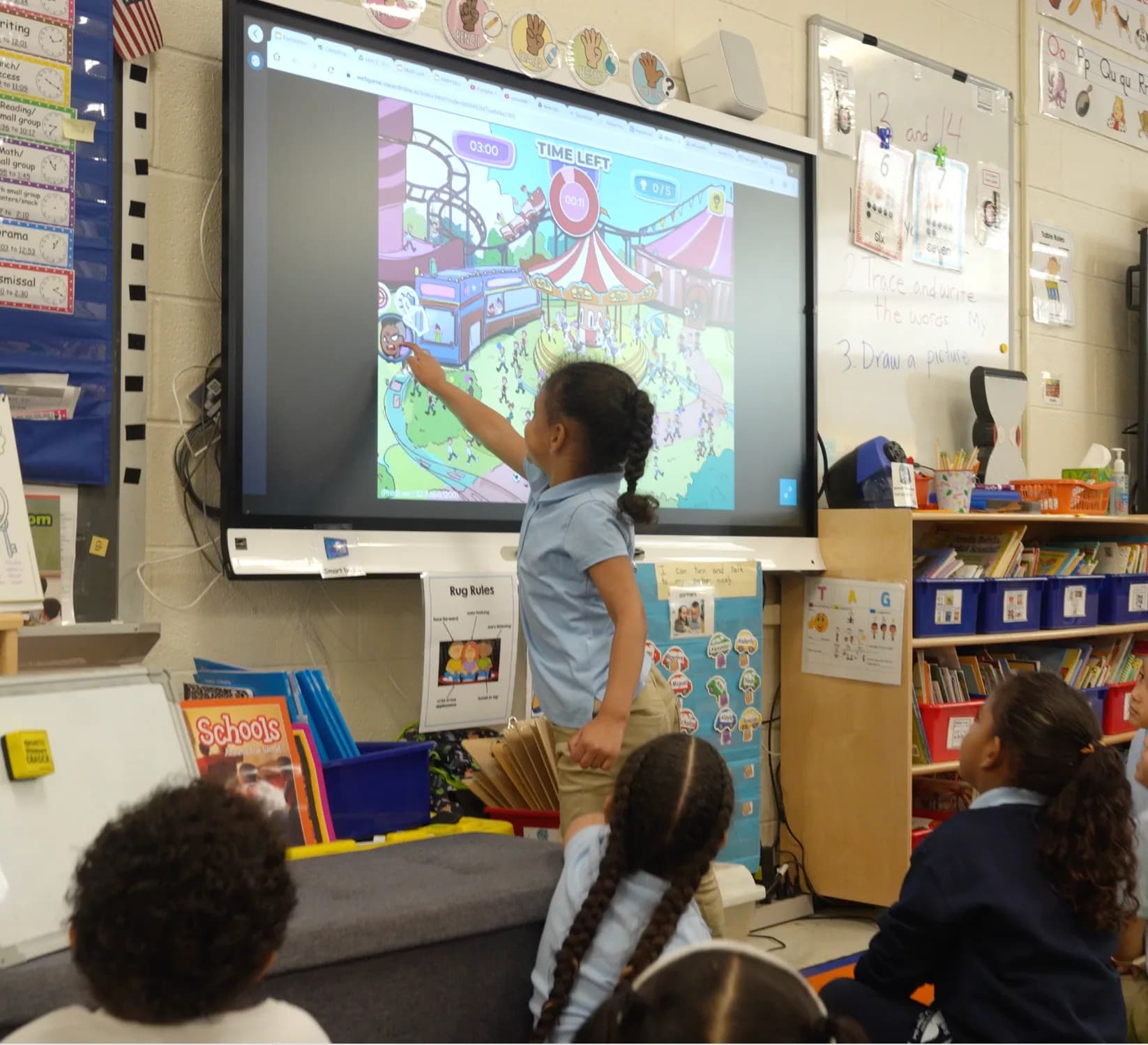 A student playing MEandMine on a classroom smartboard