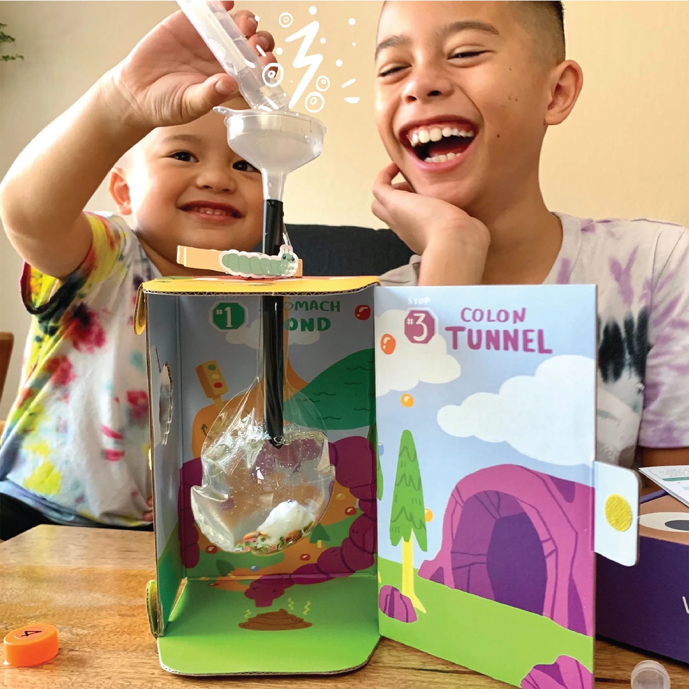 Two children laughing at a MEandMine Colon Tunnel kit