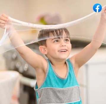 A boy stretching slime over his head