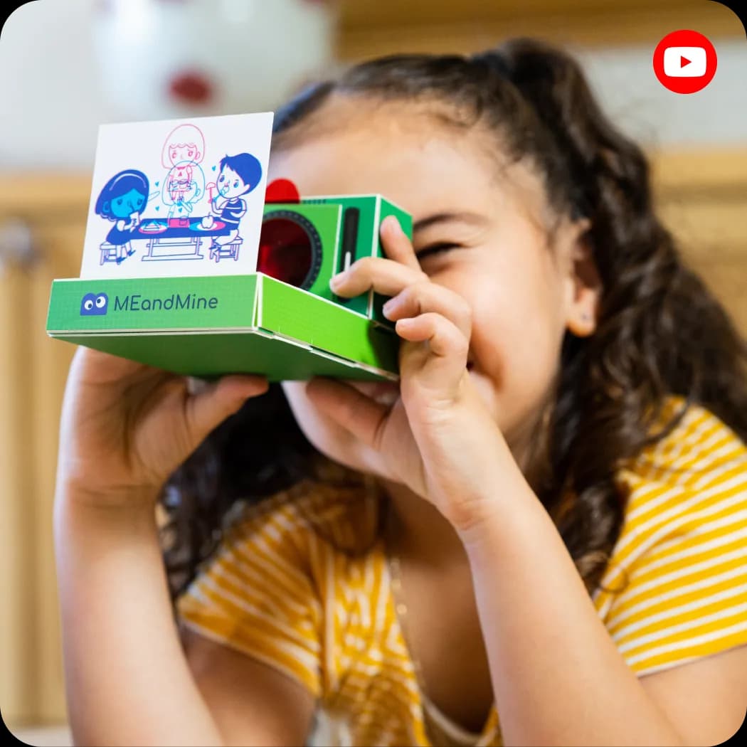 A girl looking through a green MEandMine viewer