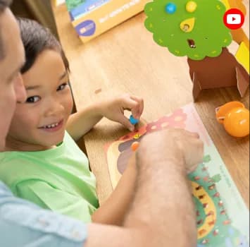 A boy and an adult building a MEandMine kit
