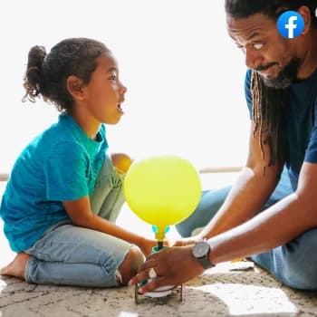 A girl and her father launching a balloon car