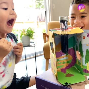 Children around a tall MEandMine science kit