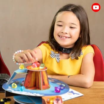 A girl spinning a colourful MEandMine kit