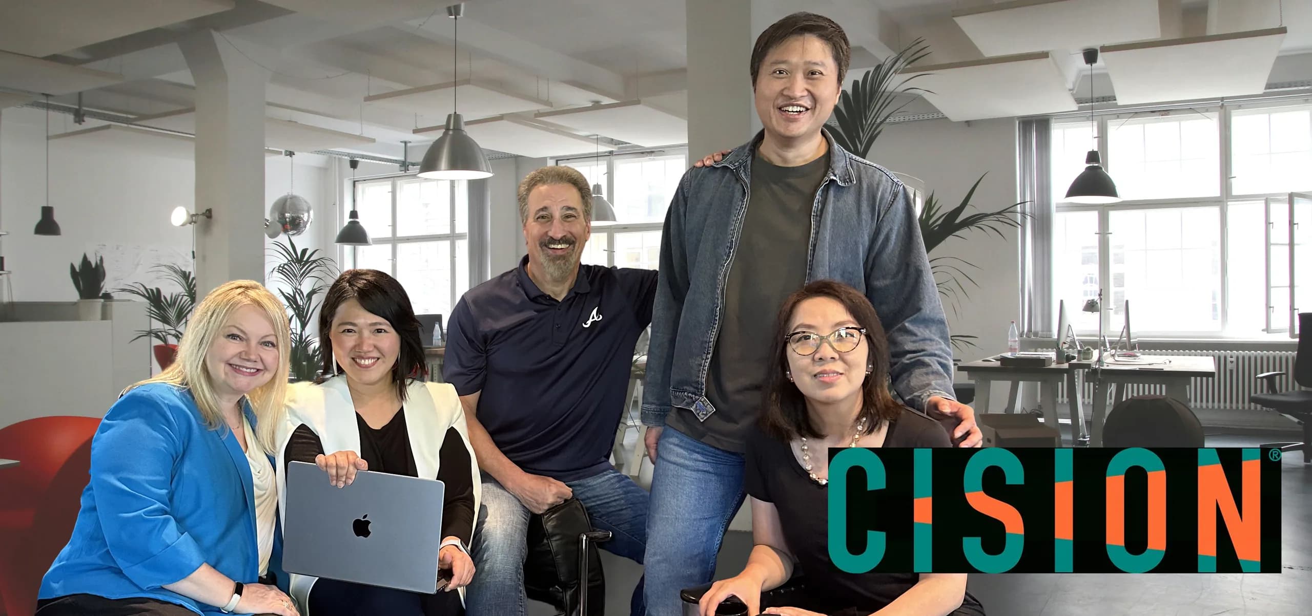 The MEandMine team in their office, with the Cision logo
