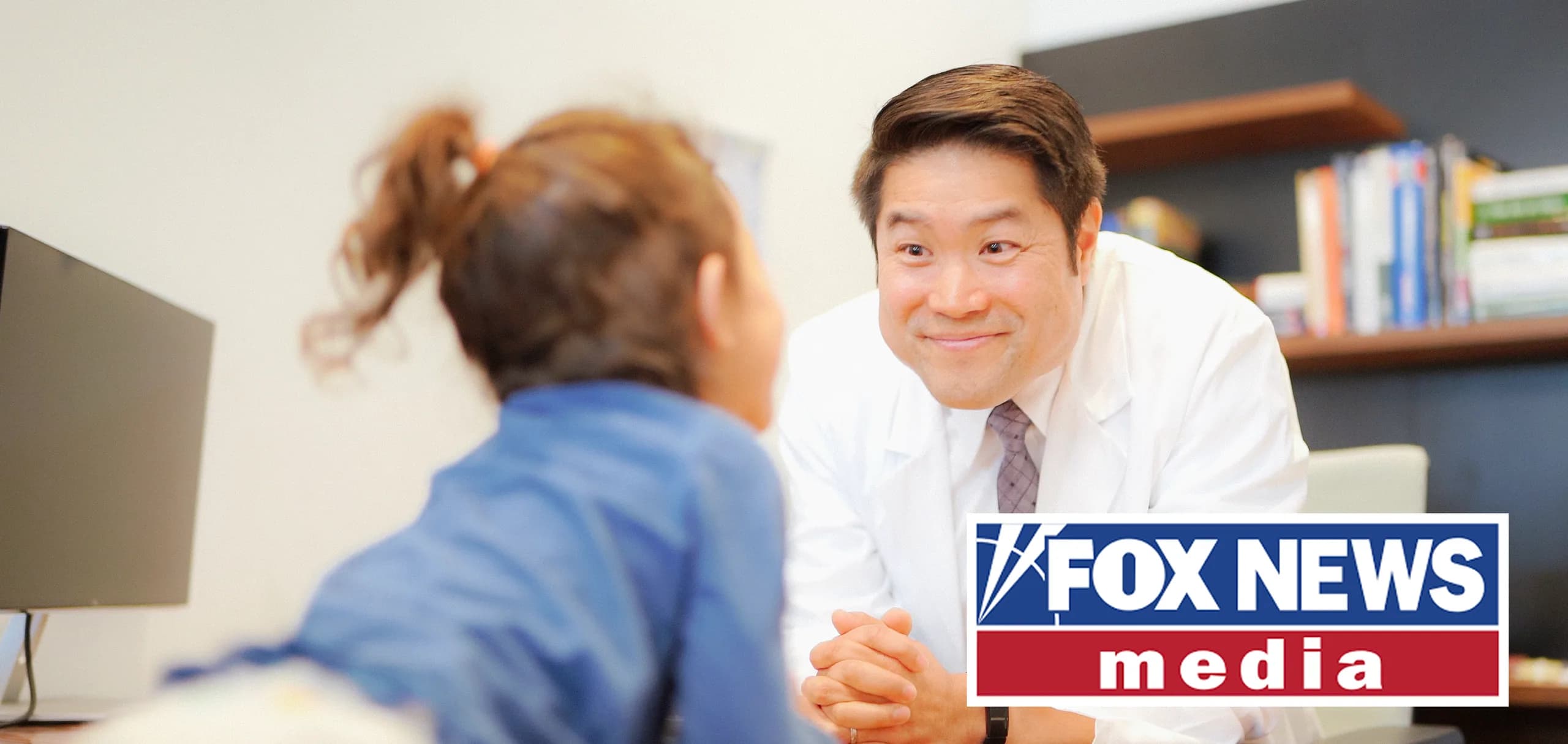 A doctor talking with a young girl, with the Fox News Media logo