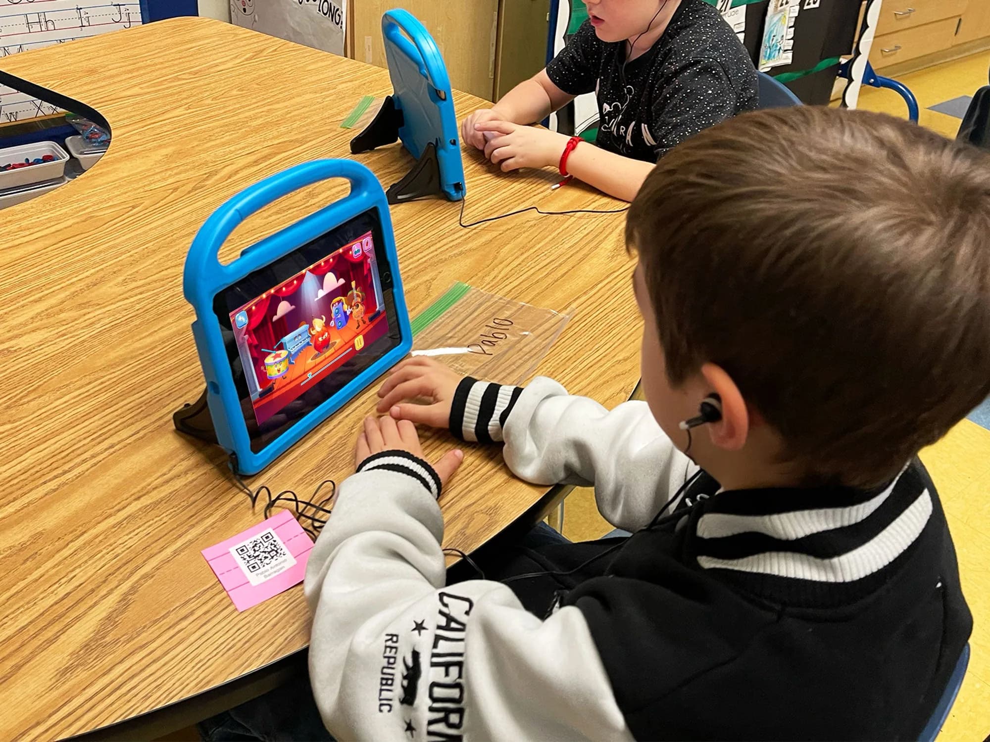 Students playing MEandMine on tablets in class
