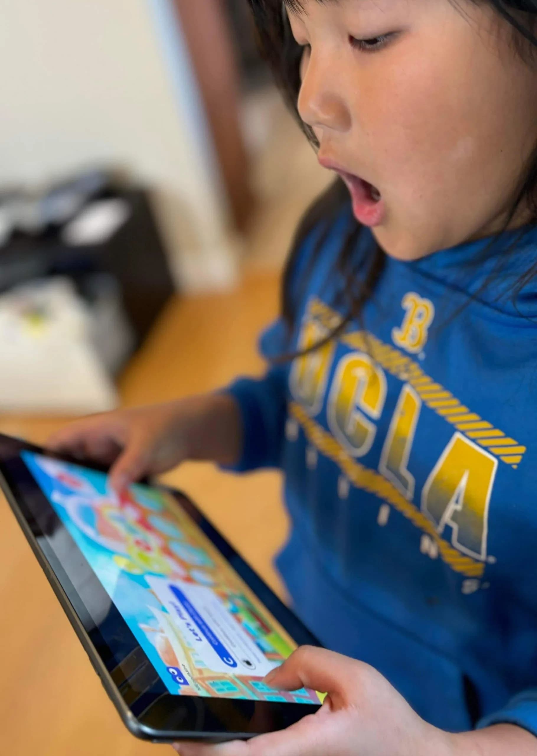 A boy playing MEandMine on a tablet