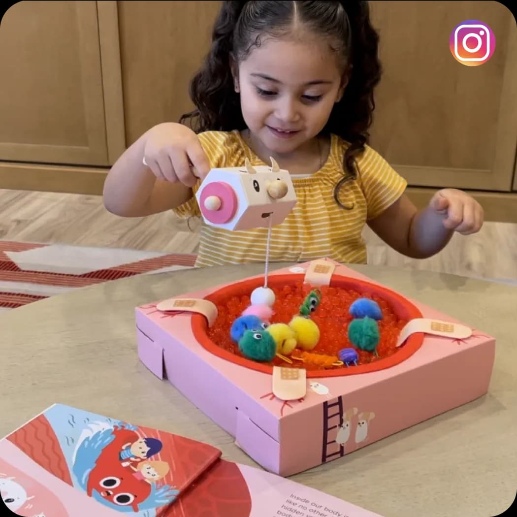 A girl playing a MEandMine game on a red tray