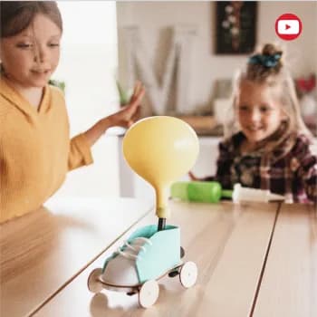 Two girls racing a balloon-powered car