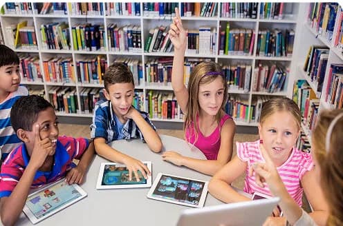 Students playing MEandMine on tablets in a library