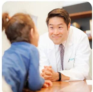 A doctor talking with a young girl