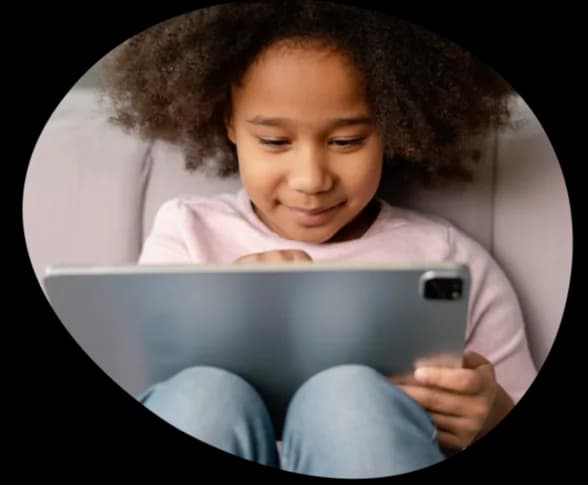 A girl playing MEandMine on a tablet