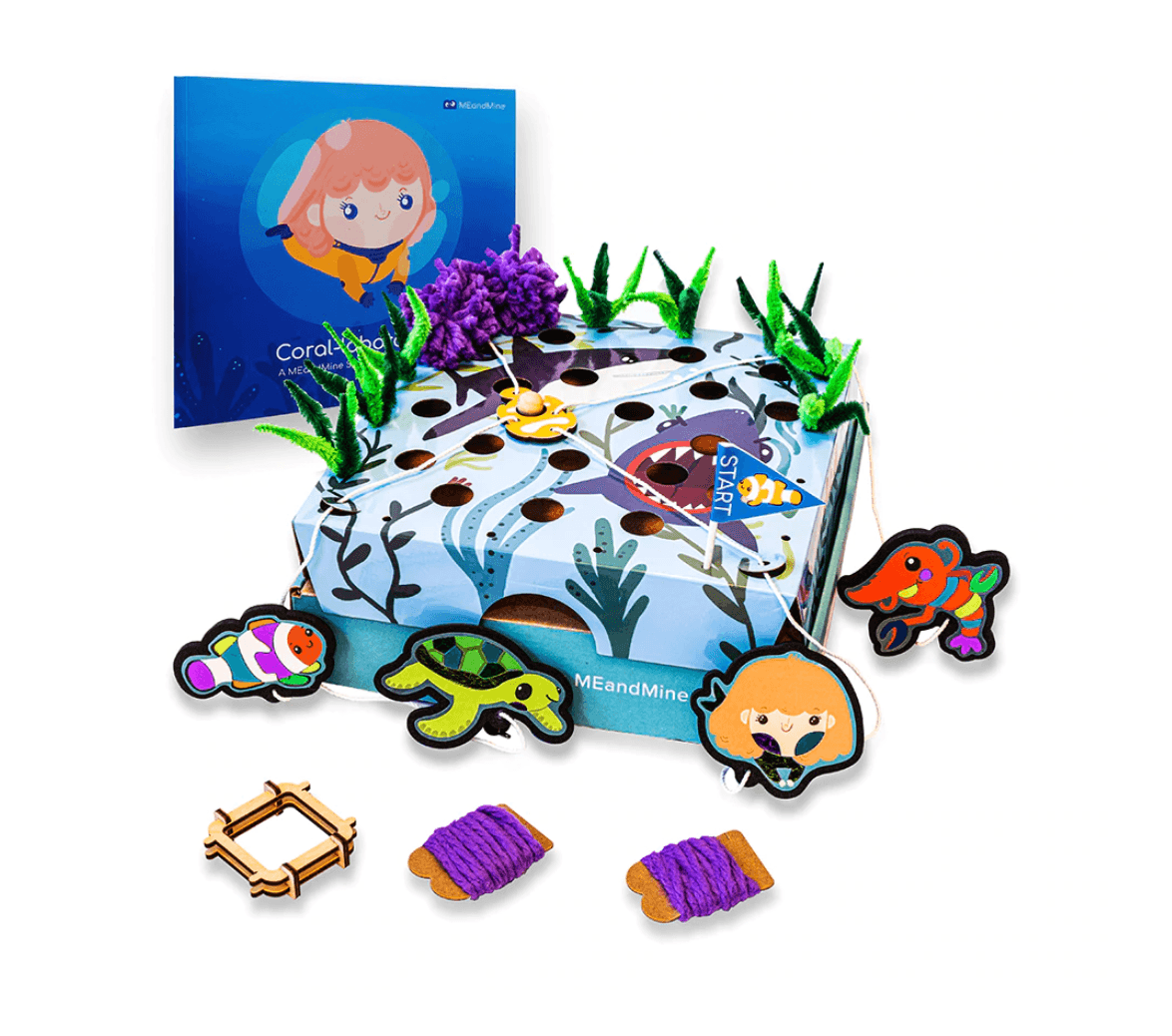 MEandMine ocean teamwork kit: a storybook, a shark-themed lacing board with pipe cleaner seaweed and sea animal figures.
