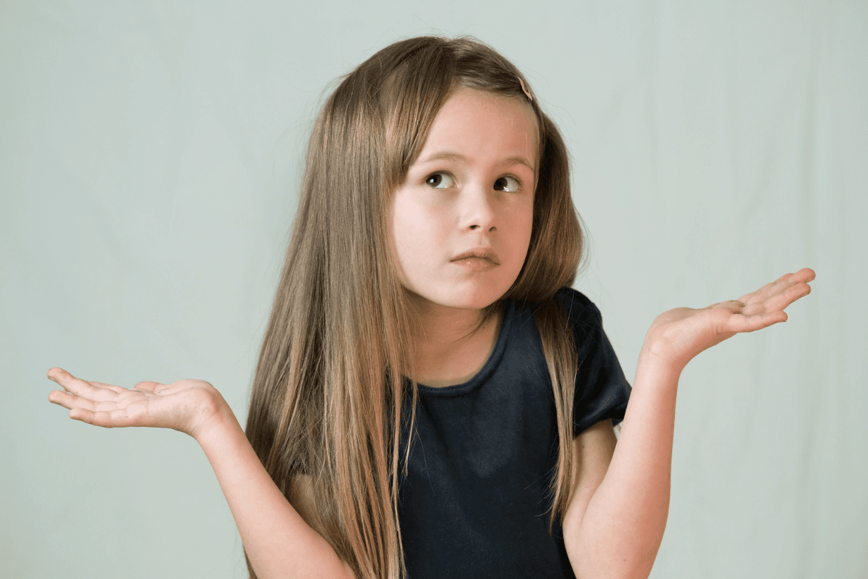 A young girl with long hair shrugs with open palms and looks up, unsure which choice to make