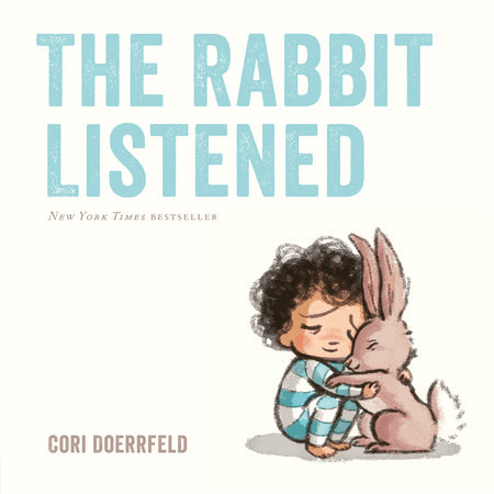 Cover of the children's book The Rabbit Listened, showing a child in striped pajamas hugging a rabbit